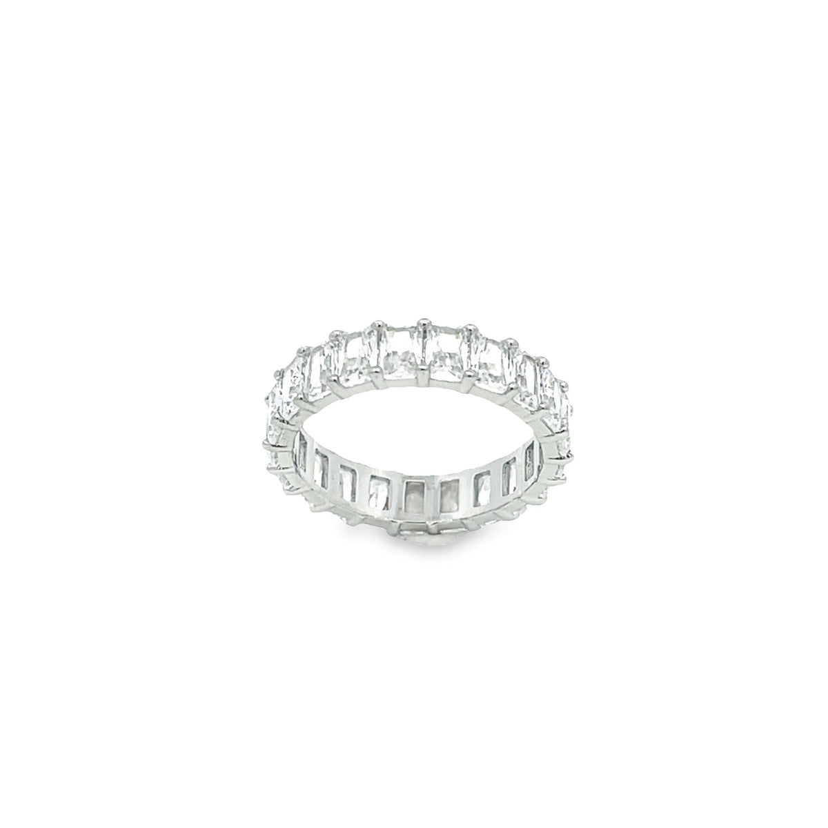 A sparkling emerald-cut diamond eternity band rests against a clean white background.