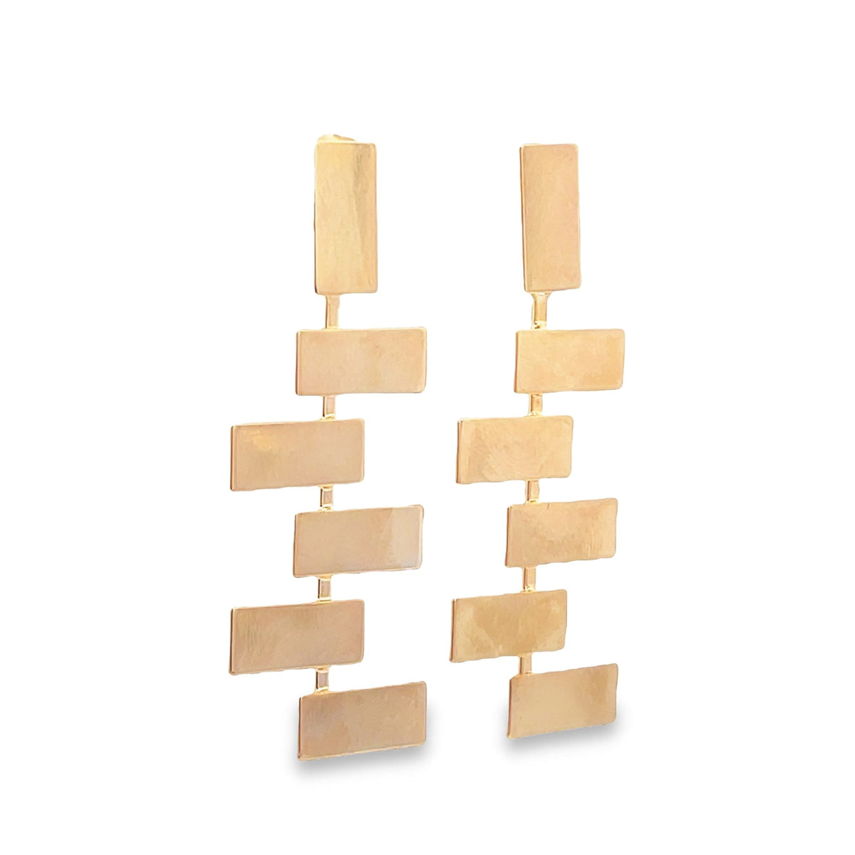 A pair of dangling gold geometric earrings features a cascading design of interconnected rectangular metal links.