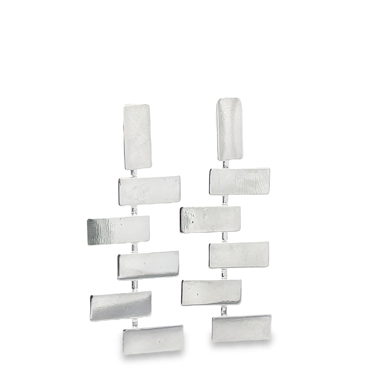A pair of modern silver geometric drop earrings featuring stacked rectangular metal bars against a clean white background.