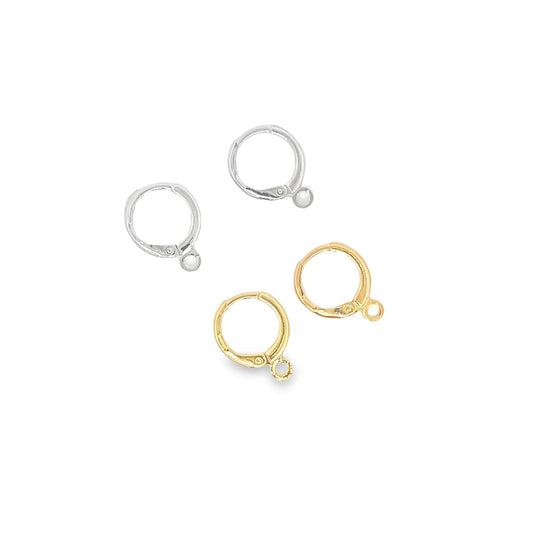 Four leverback earring findings in silver and gold metal lie arranged on a white background.