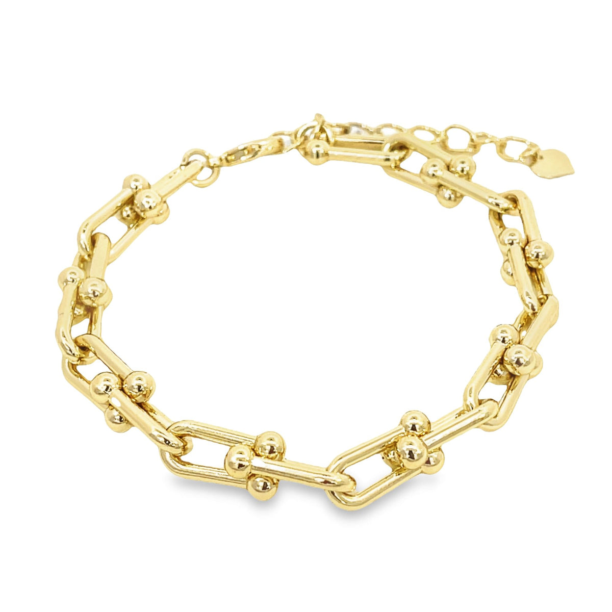 A polished gold link bracelet showcases interlocking elongated links accented with small spherical balls against a white background.