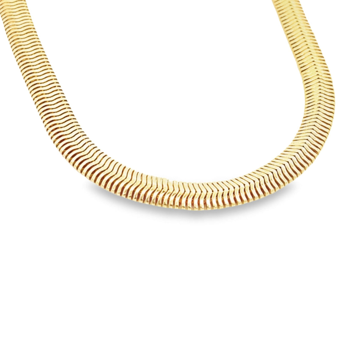 A wide, polished gold herringbone chain necklace curves elegantly against a clean white background.