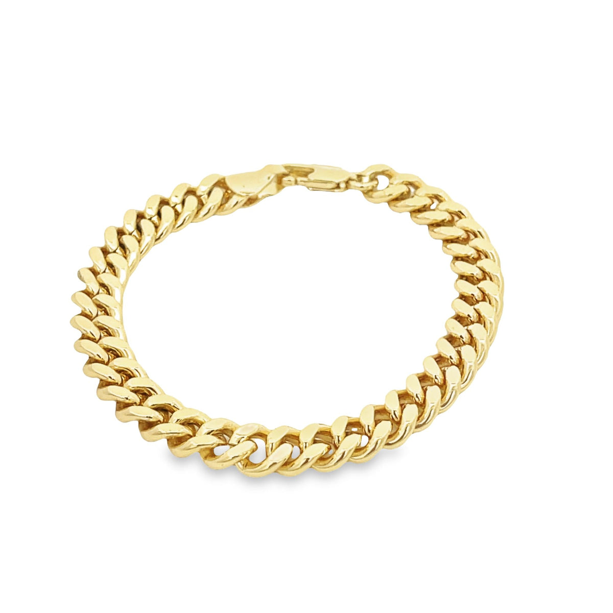 A classic gold cuban link bracelet gleams against a plain white background.