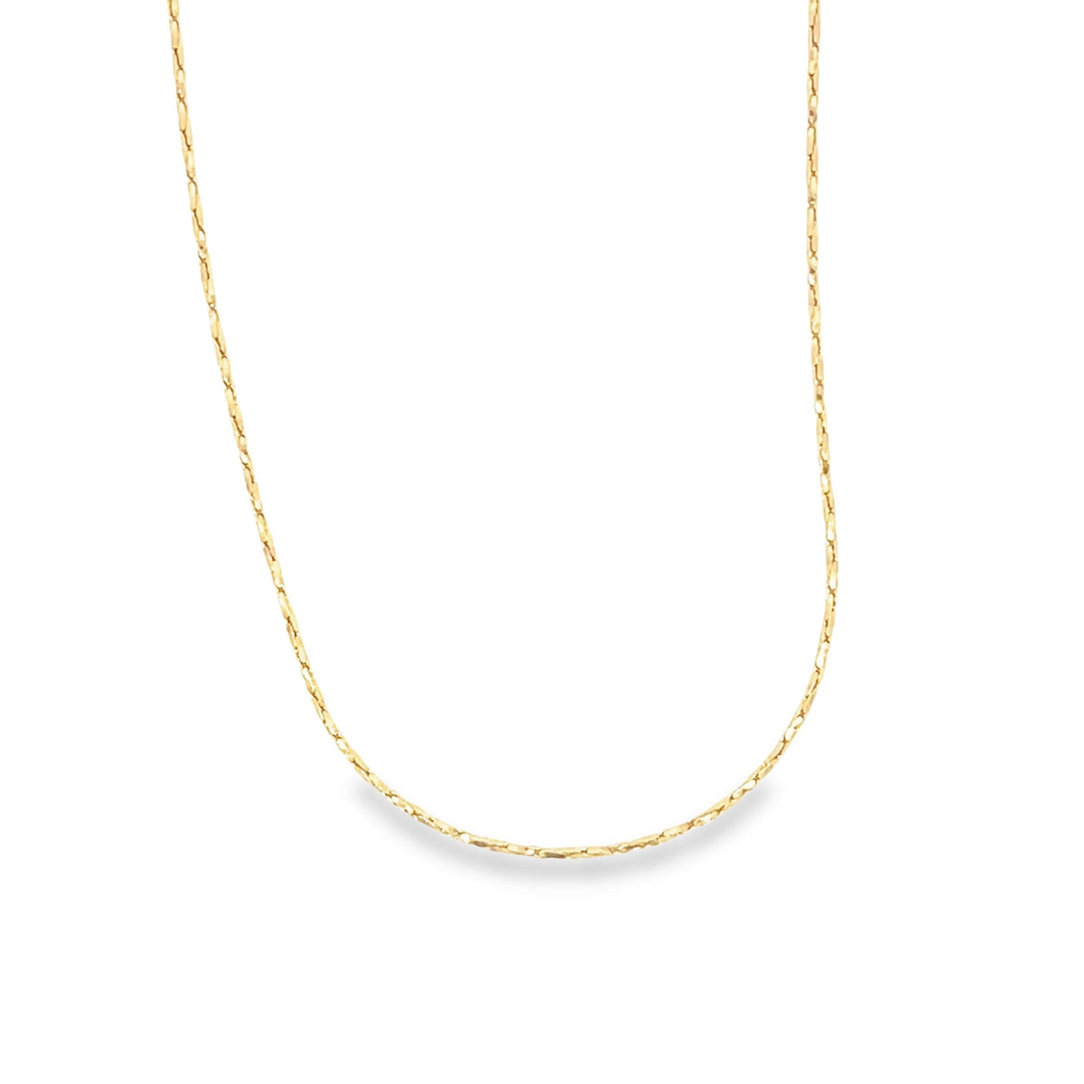 A delicate gold chain necklace drapes gracefully against a plain white background.