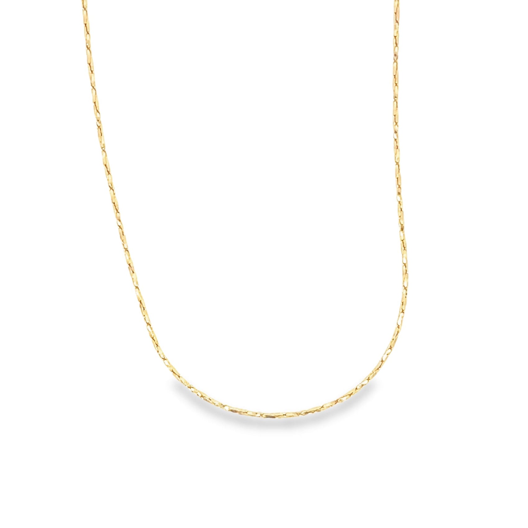 A delicate gold chain necklace drapes in a smooth curve against a clean white background.
