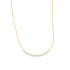 A delicate gold chain necklace drapes gracefully against a plain white background.