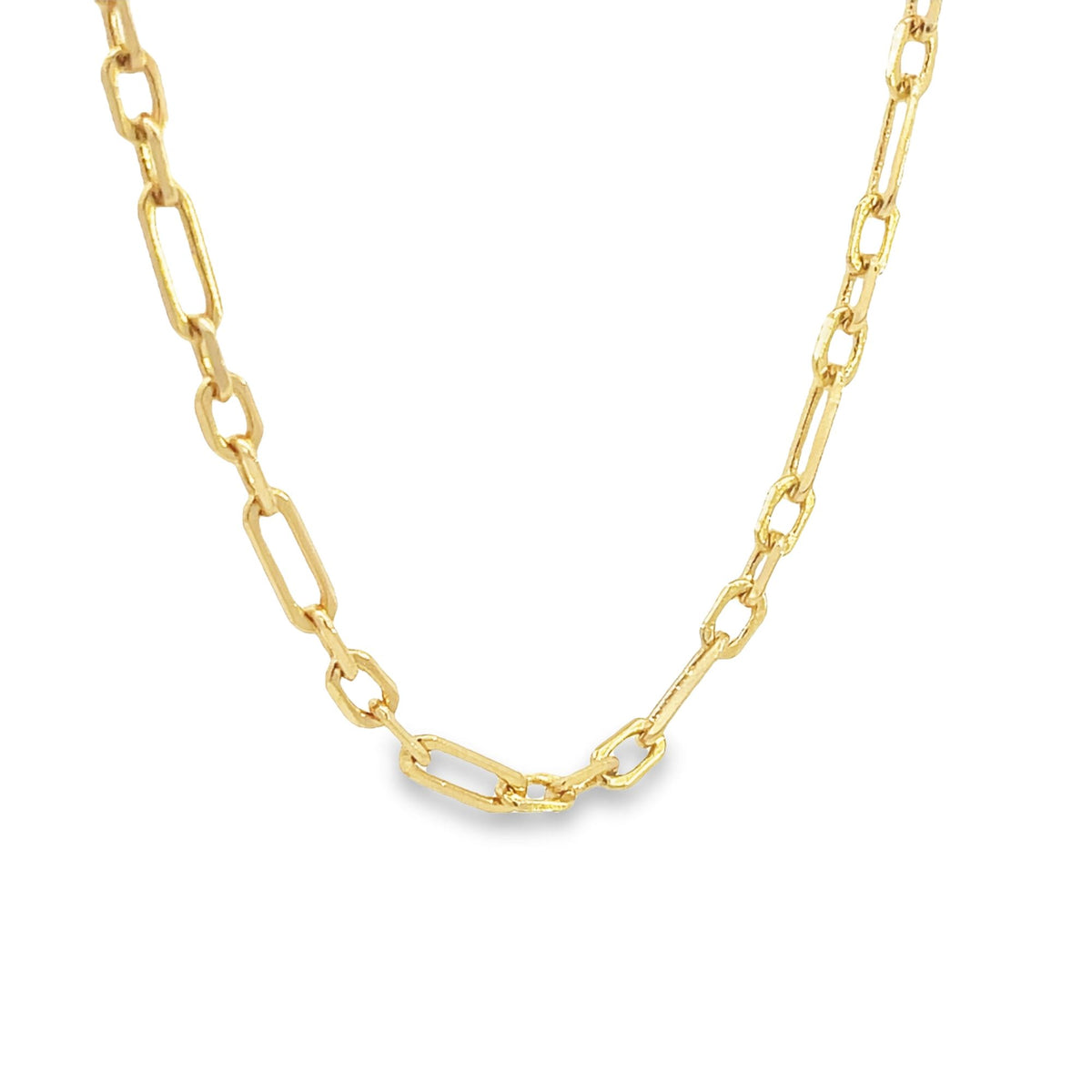 A shiny gold paperclip chain necklace drapes against a clean white background.
