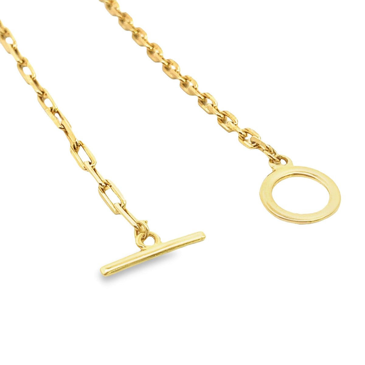 A gold toggle clasp necklace features an ornate link chain with a t-bar and ring closure against a white background.