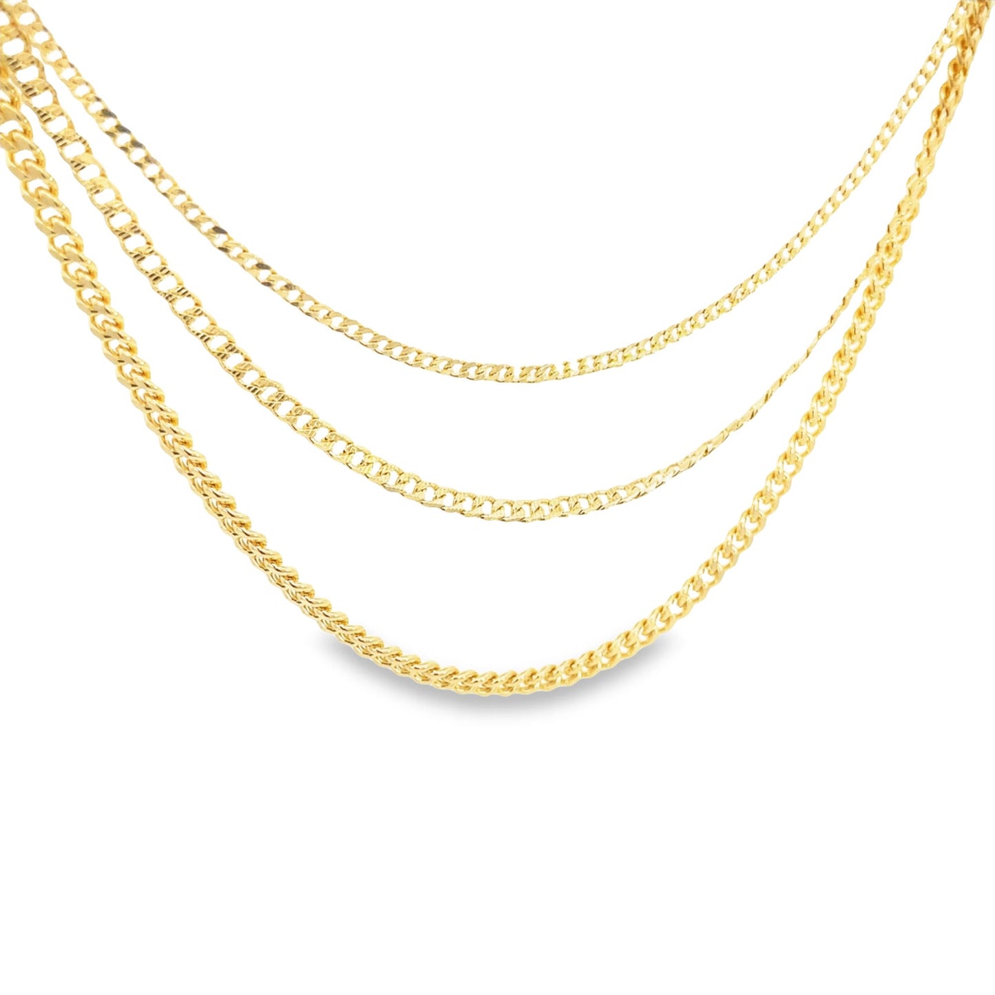Three layered gold chains in different link styles drape gracefully against a plain white background.