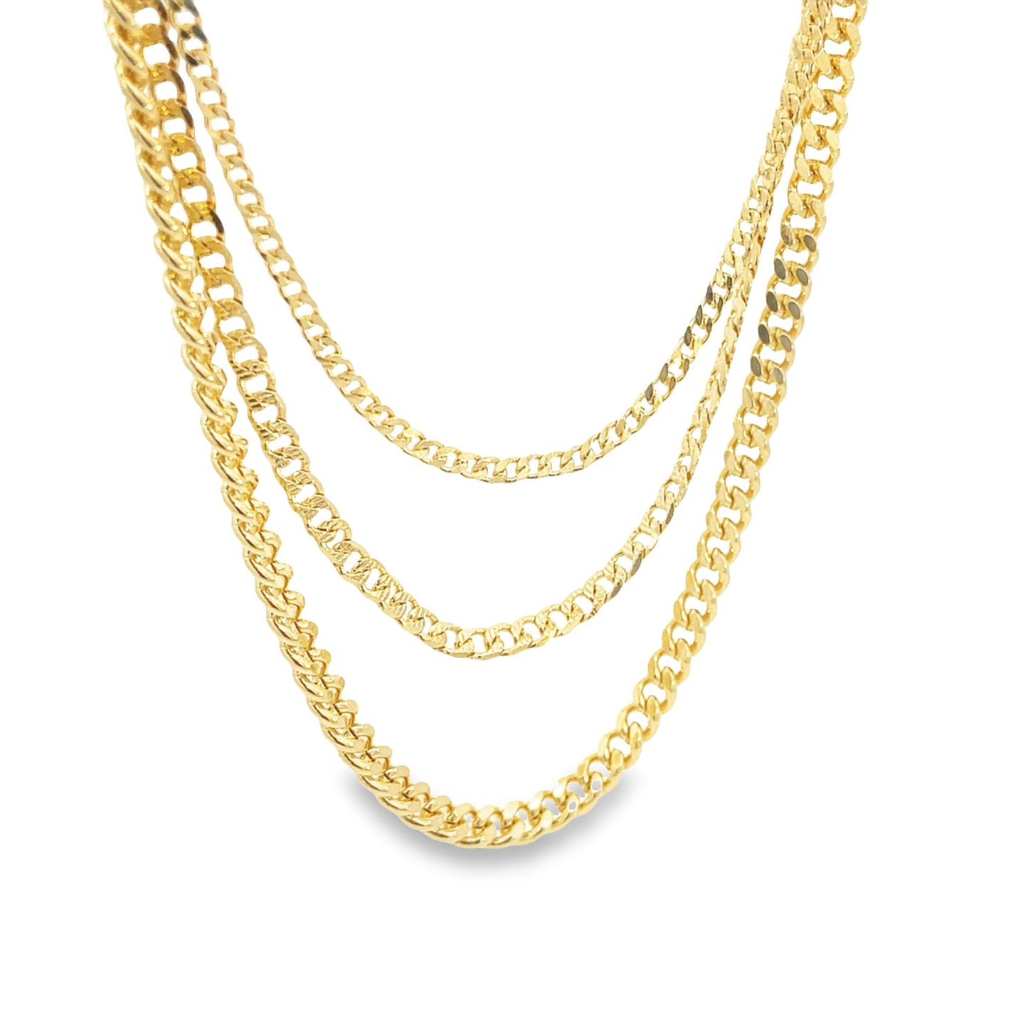 Three layered gold cuban link chains drape gracefully against a clean white background.