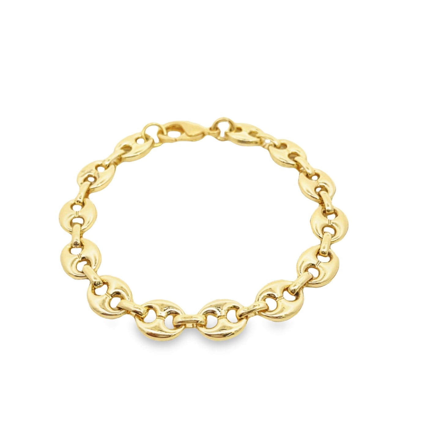A shiny gold puff mariner link bracelet rests in a circle on a clean white background.