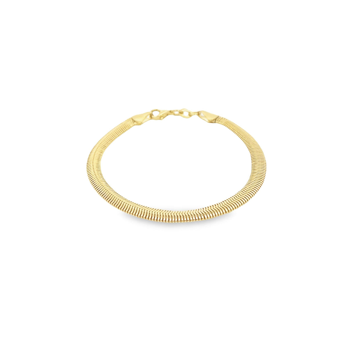 A sleek gold herringbone chain bracelet curves gracefully on a clean white background.