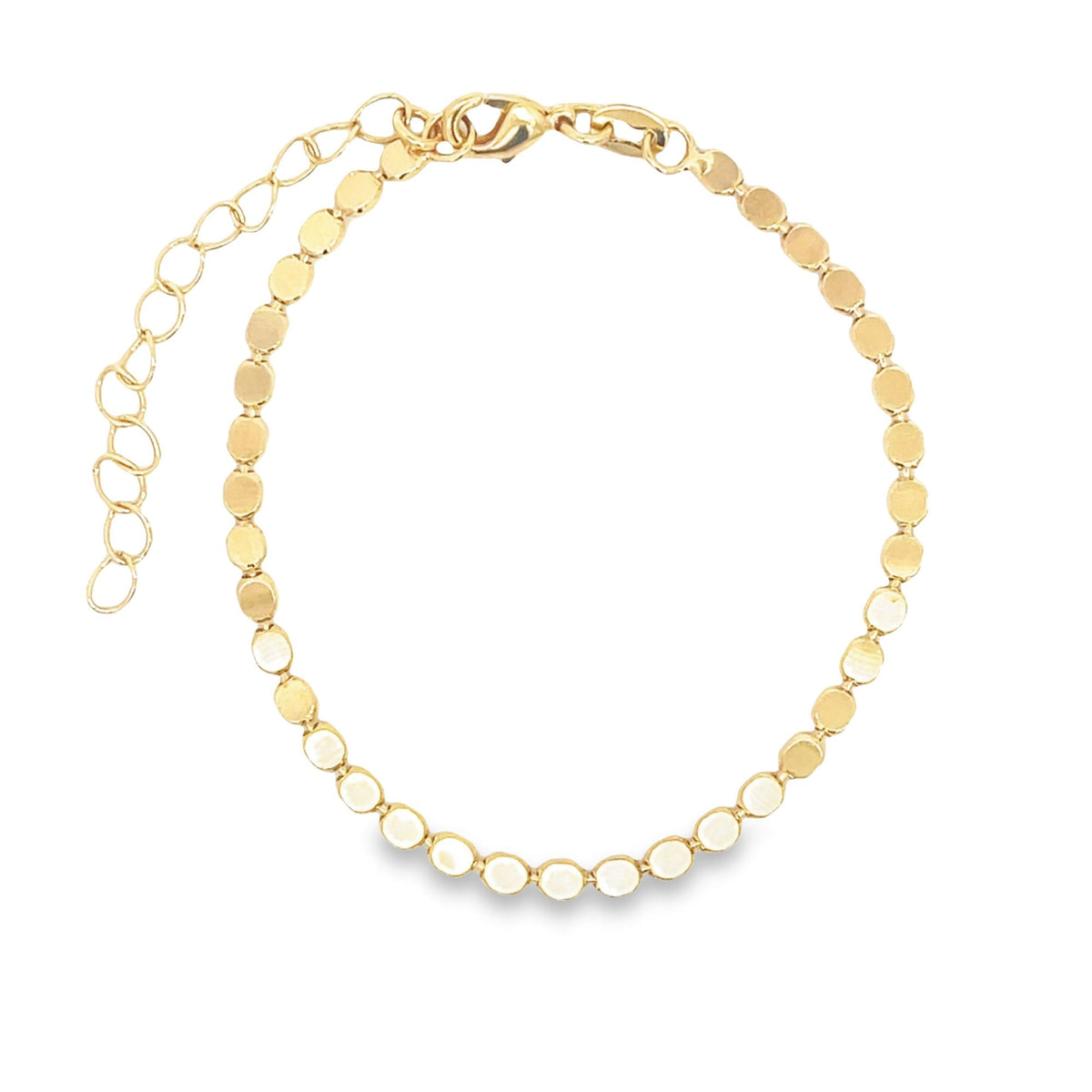 A delicate gold chain bracelet features flat, shimmering circular disks and an adjustable extender clasp.