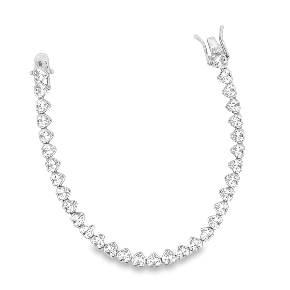 A sparkling silver heart-shaped tennis bracelet features a secure box clasp against a white background.