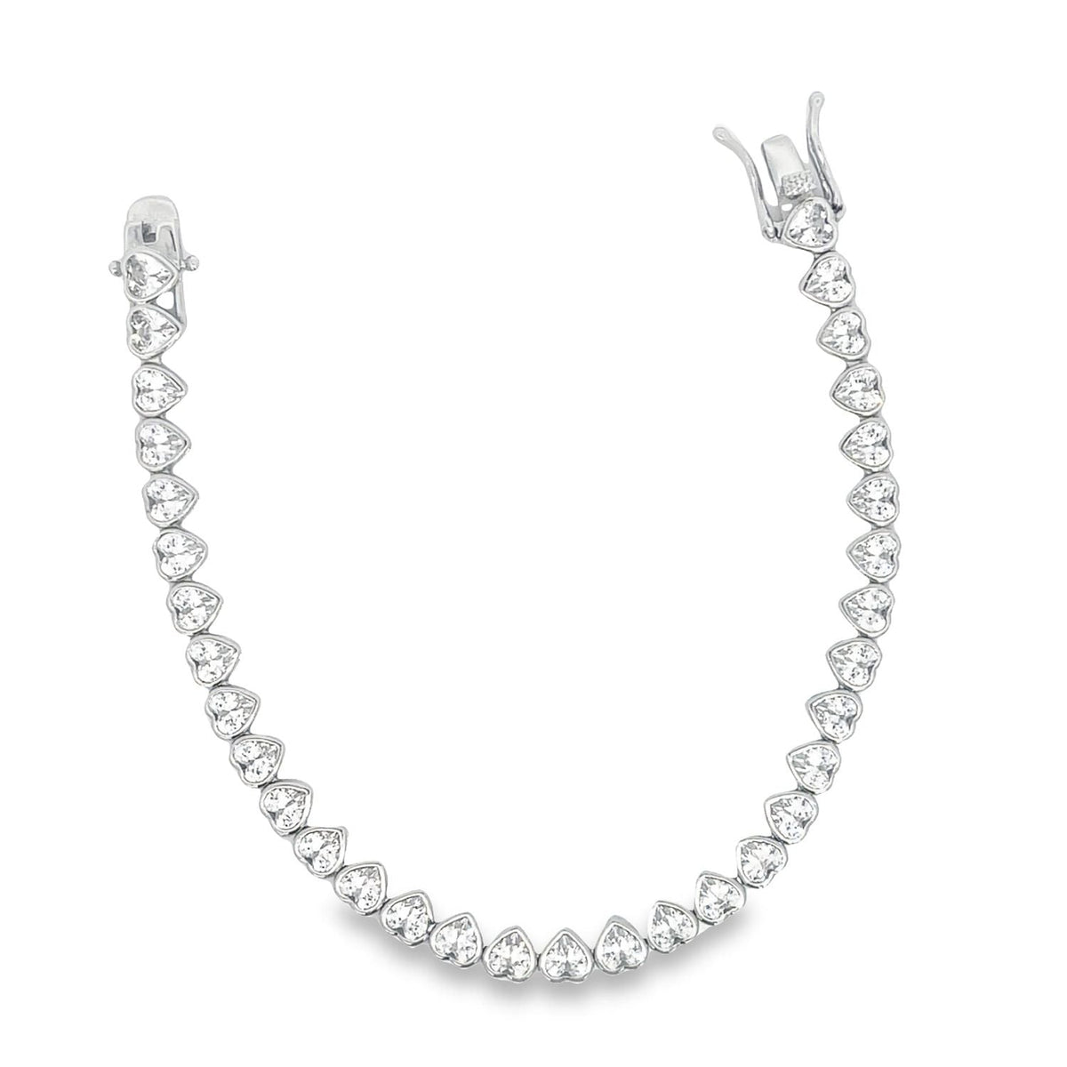 A sparkling white gold tennis bracelet features a continuous line of brilliant heart-cut diamonds arranged in a delicate prong setting against a clean white background.