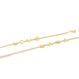 Two gold tennis bracelets studded with diamonds spell out the words "LOVE" and "MAMA" with letter charms.