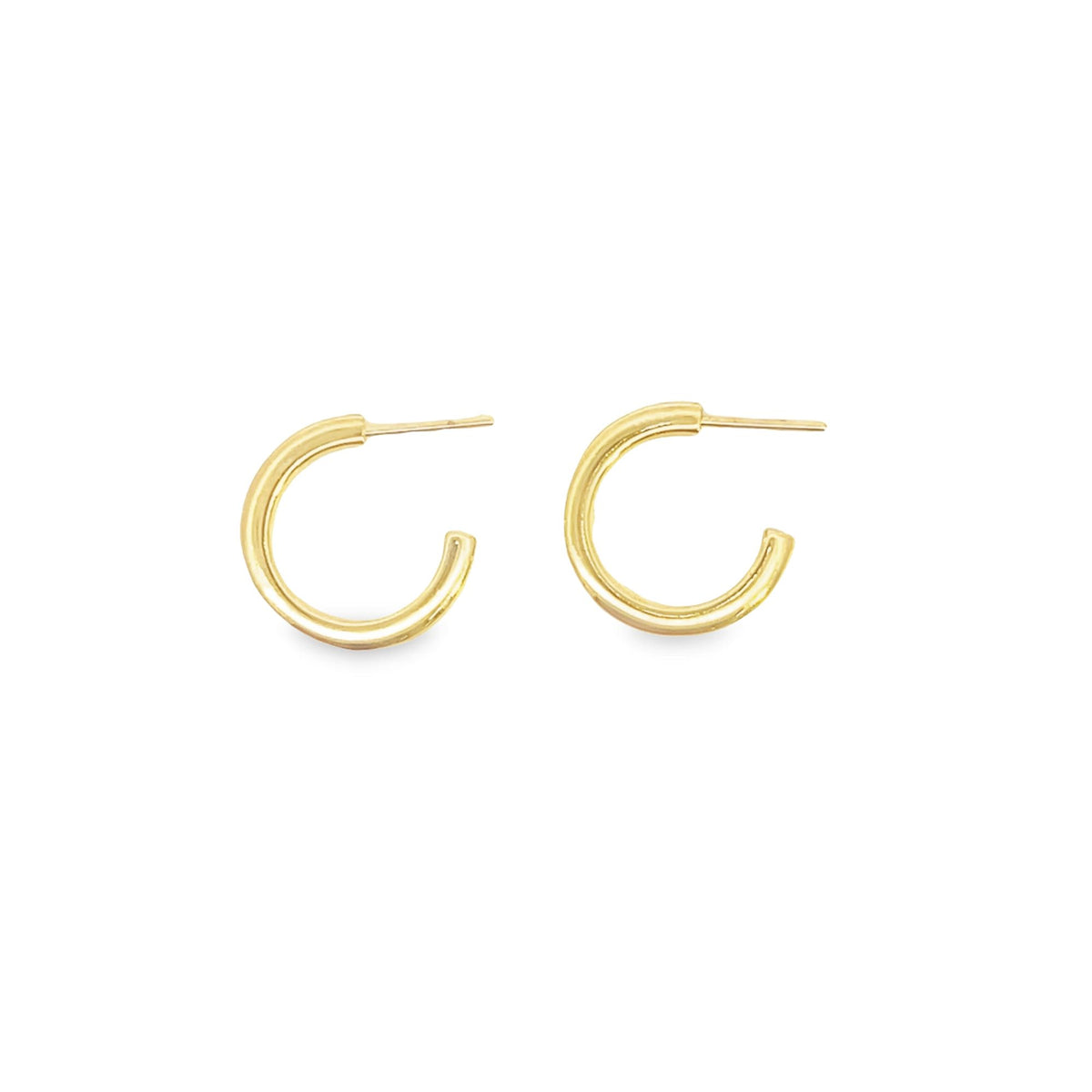 A pair of shiny gold hoop earrings rests against a clean white background.