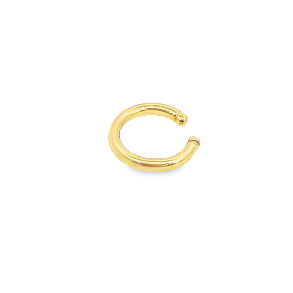 A polished gold hoop cartilage earring rests against a clean white background.