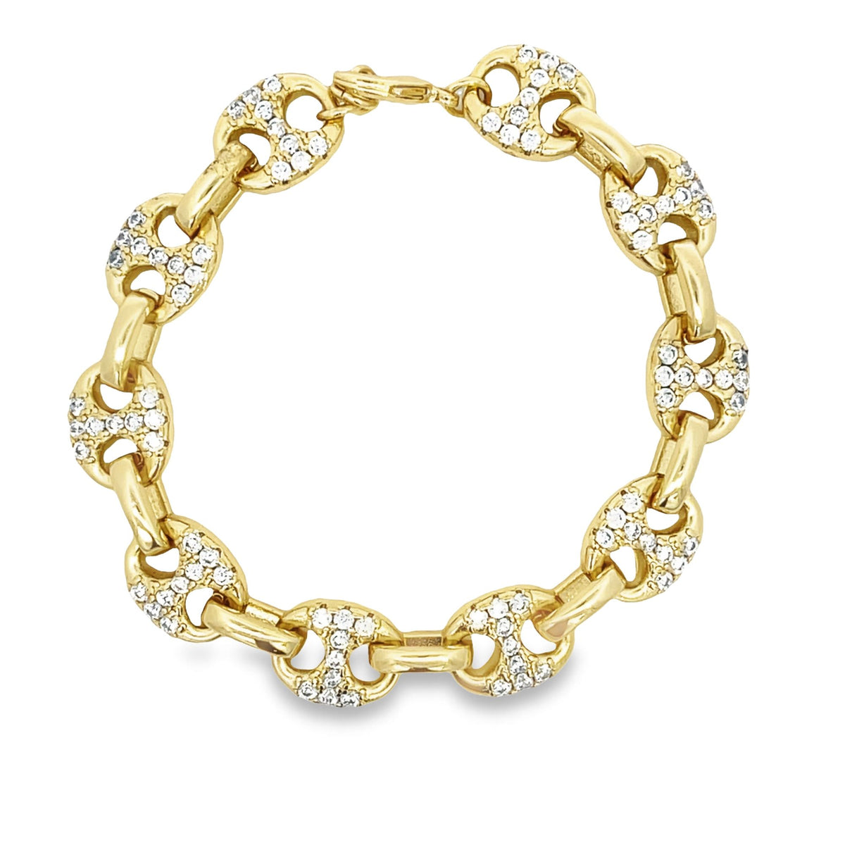 A gold link bracelet encrusted with sparkling diamonds rests in a circle on a plain white background.