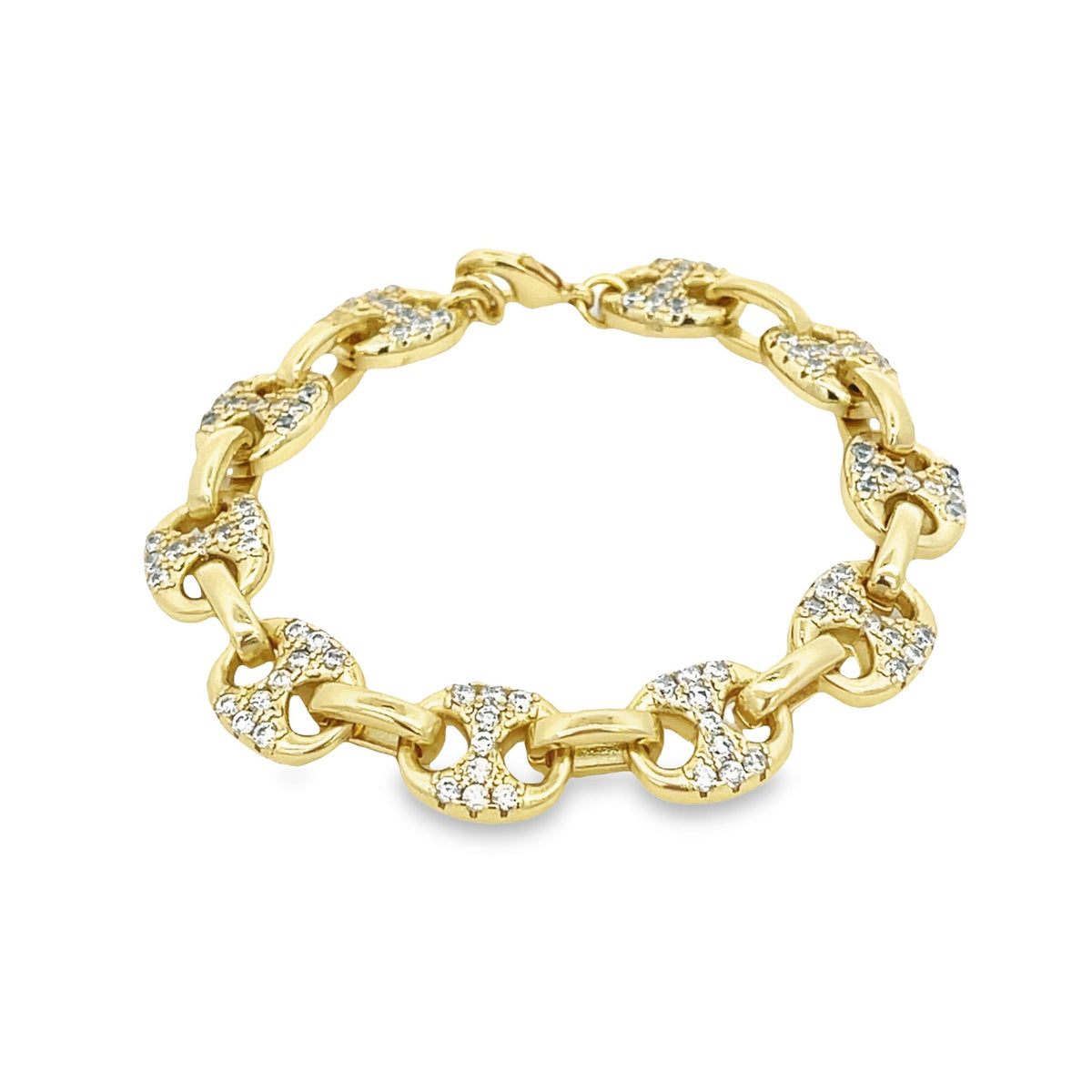A gold link bracelet featuring interlocking anchor-shaped links embedded with sparkling pavé diamonds is displayed on a clean white background.