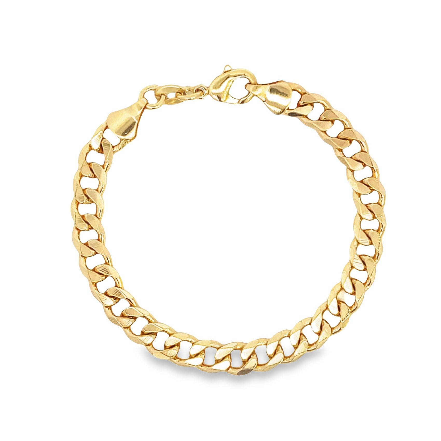 A shiny gold curb chain bracelet curves into a circle on a white background.