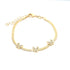 A gold snake chain bracelet features three sparkling crystal-embellished butterfly charms and an adjustable extension chain on a plain white background.