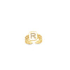 A gold initial ring features a pave diamond letter R on a brick-patterned band.