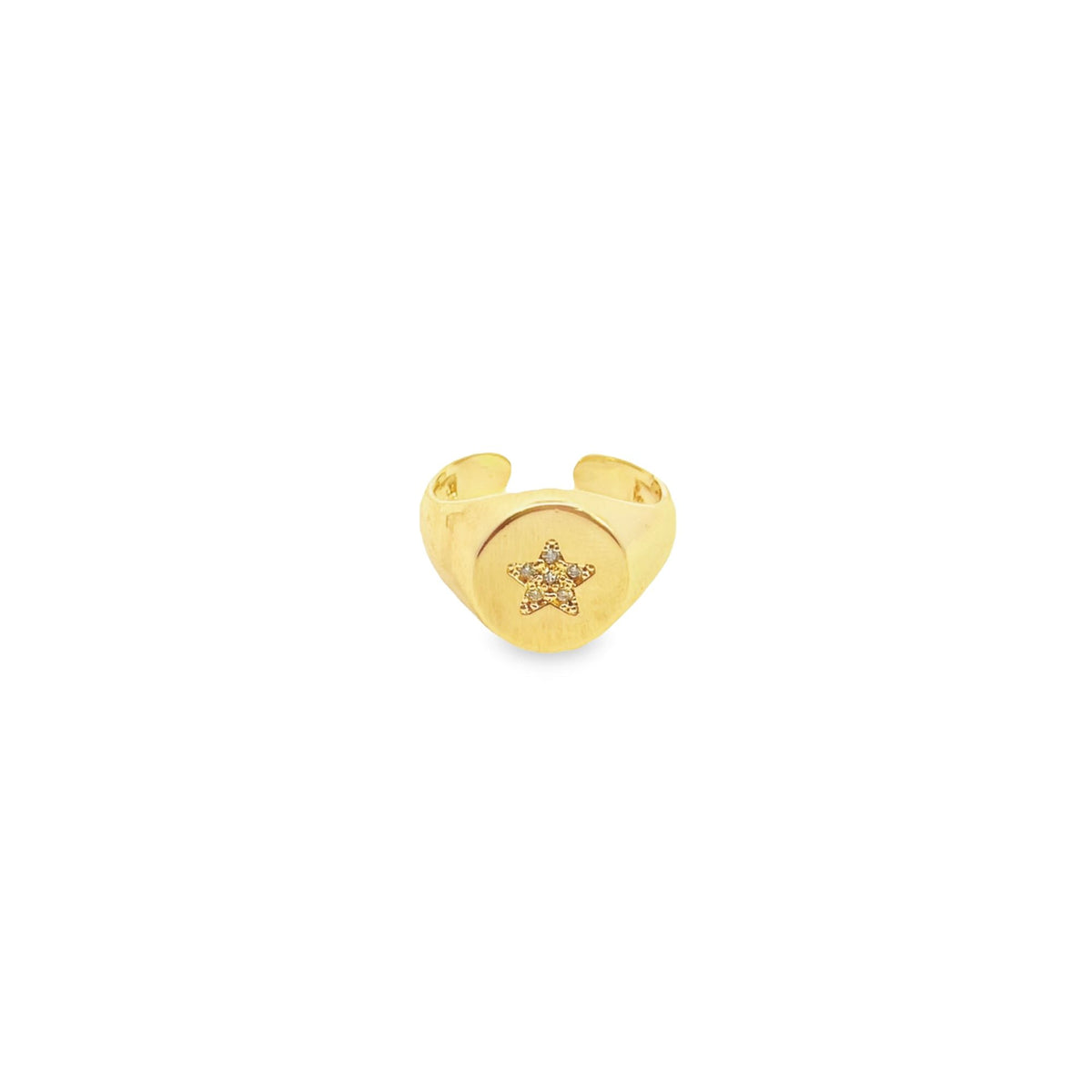 A gold signet ring features a sparkling diamond-pave star centered on its face.