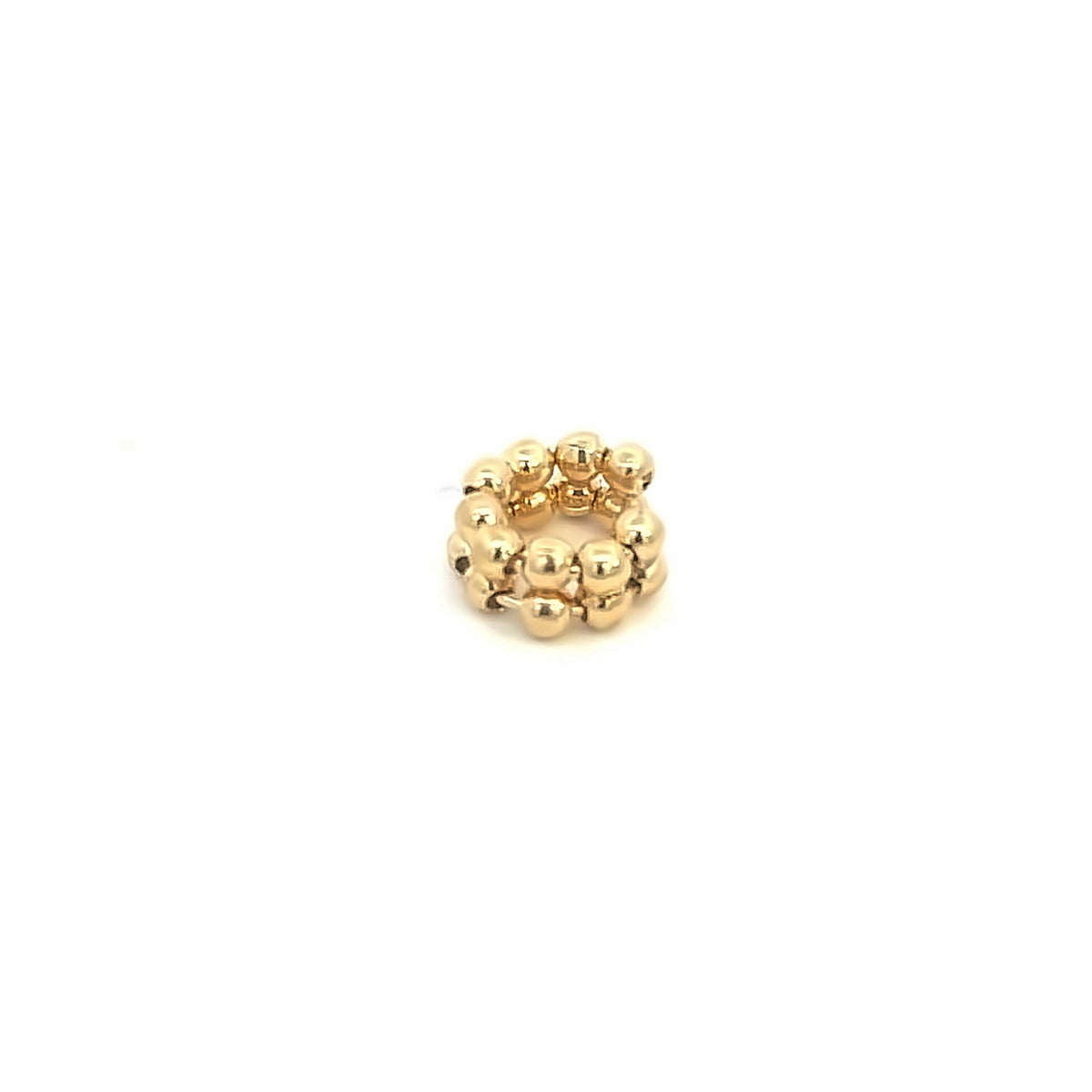 A polished gold beaded ear cuff rests against a clean white background.