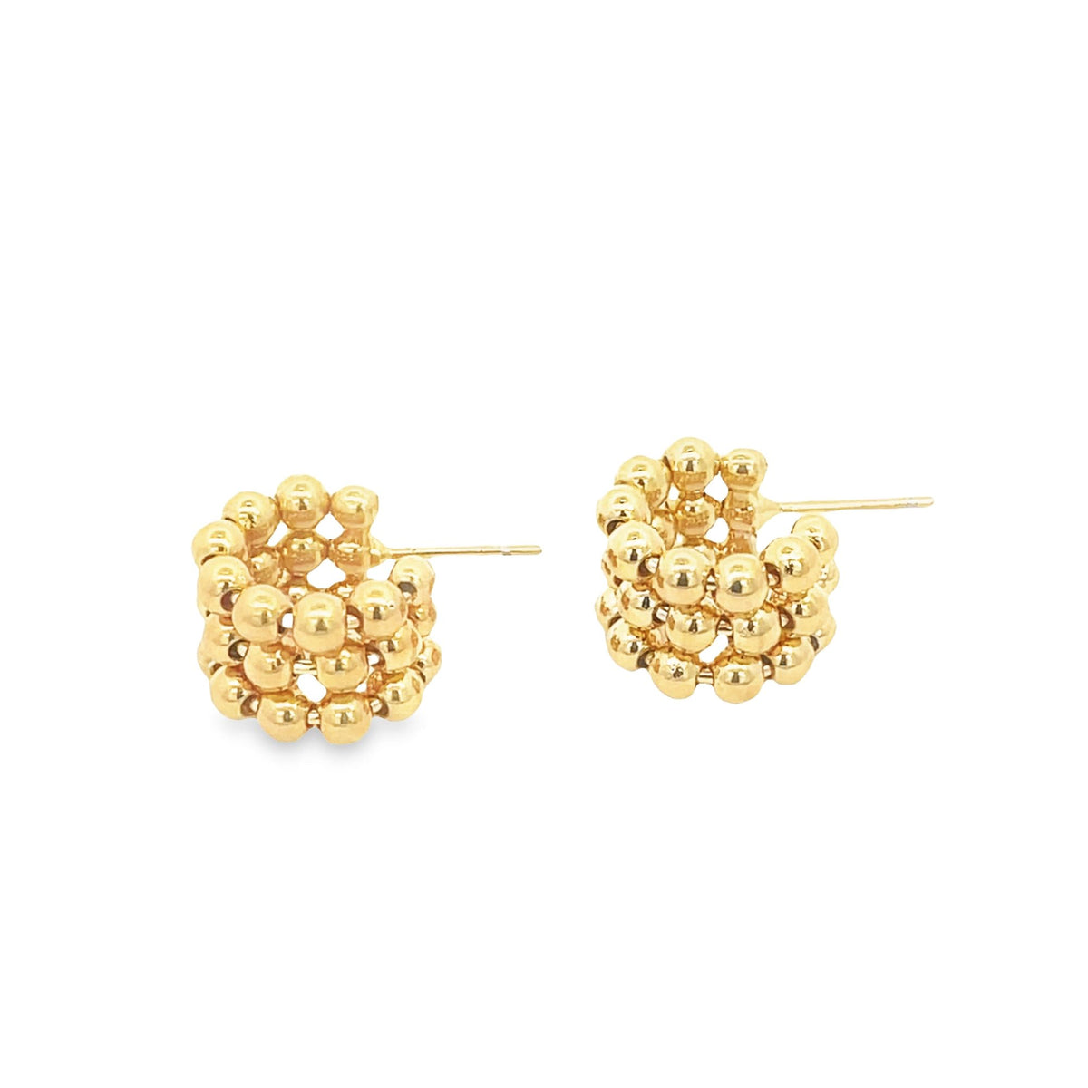 A pair of textured gold hoop earrings crafted from clusters of tiny polished beads rests on a clean white background.