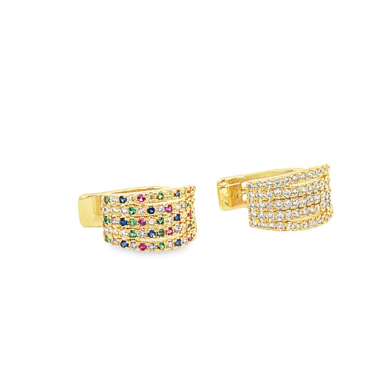 A pair of gold huggie hoop earrings features rows of sparkling multicolored gemstones against a clean white background.