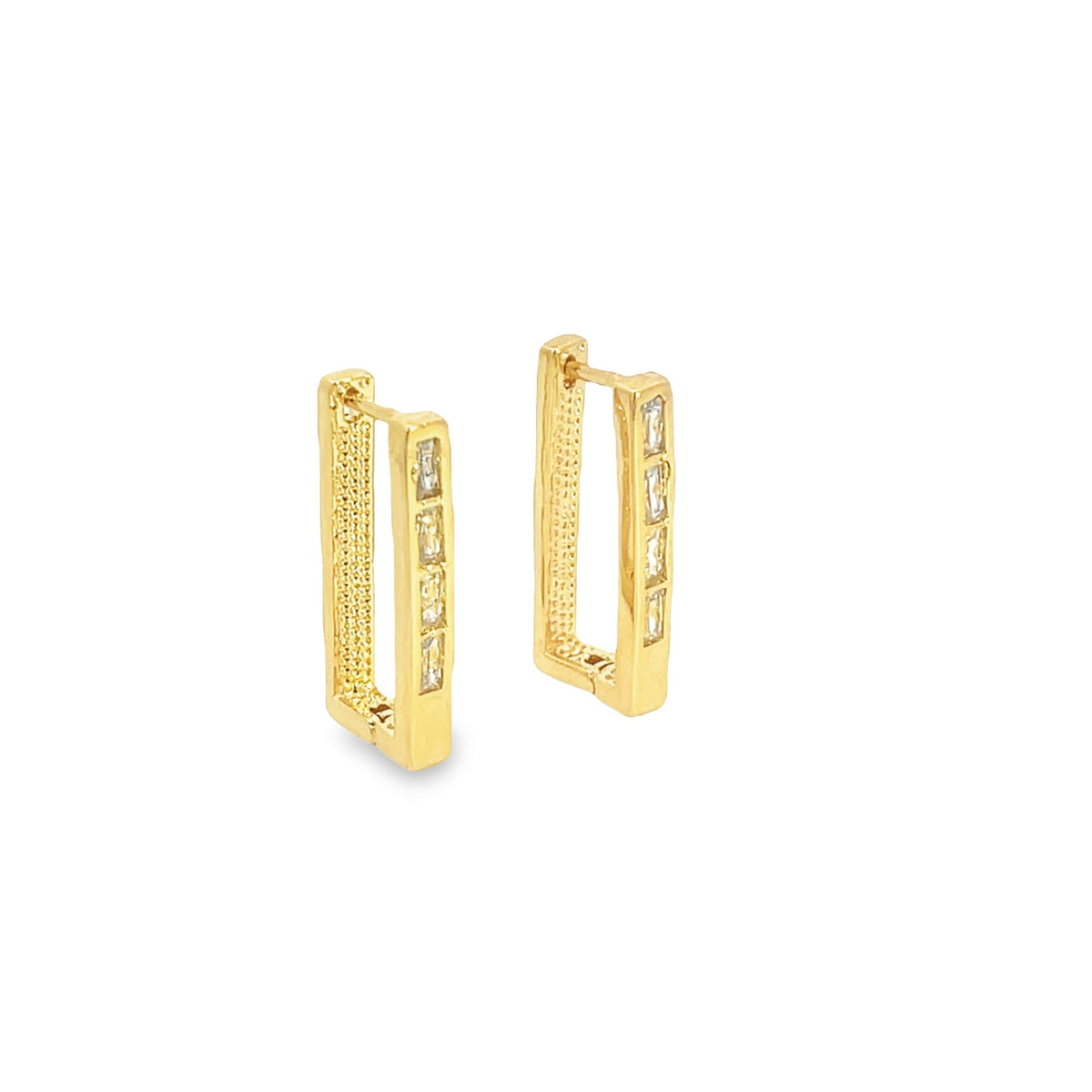A pair of gold rectangular huggie hoop earrings featuring sparkling baguette-cut stones along the front.