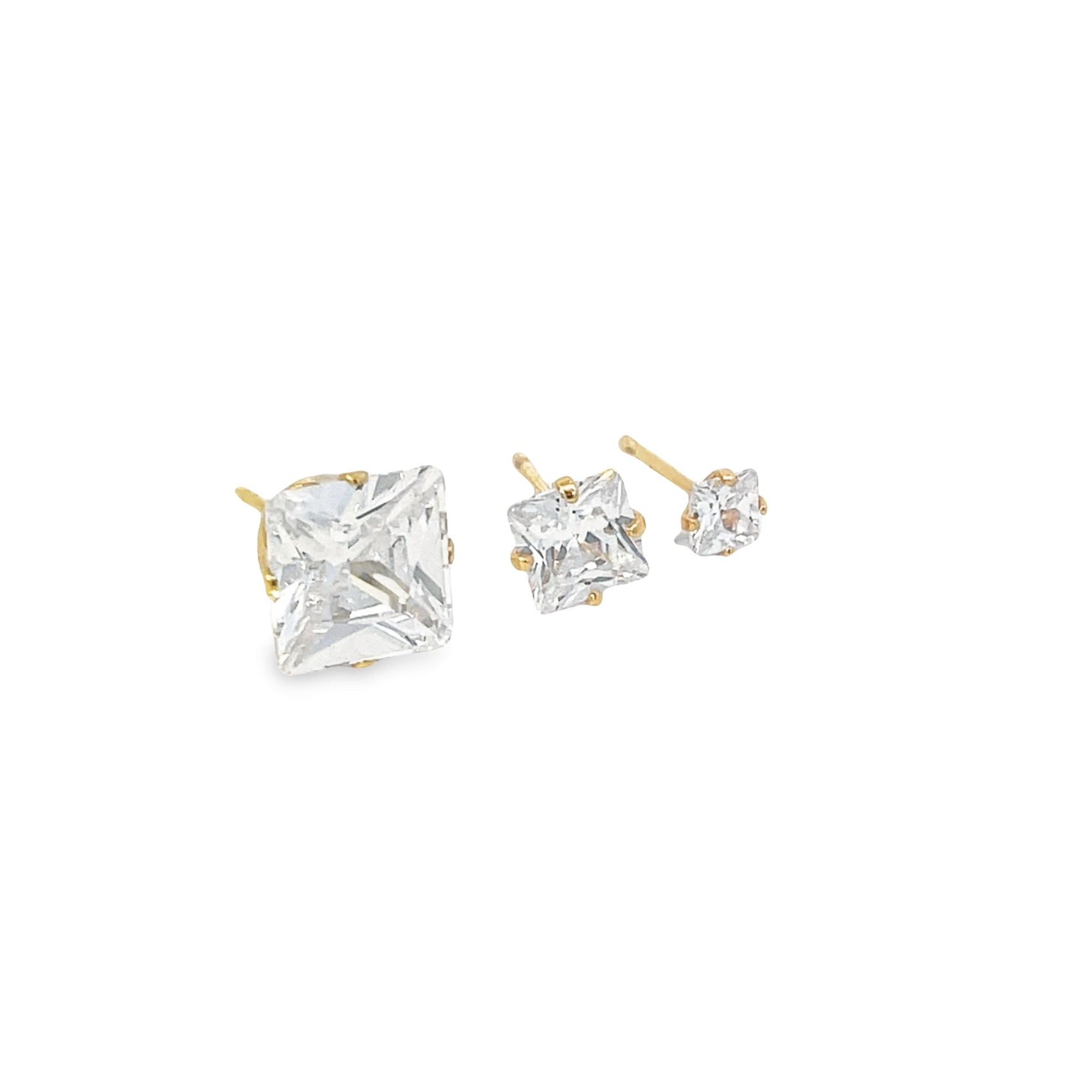 Three graduated square-cut cubic zirconia stud earrings in gold settings rest against a white background.
