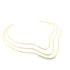 A minimalist triple-strand gold choker necklace rests in a graceful wave shape against a white background.