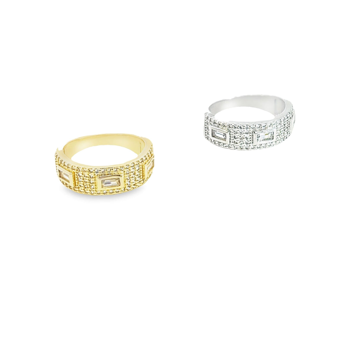 Two pave-set crystal eternity rings, one in gold and one in silver, rest side by side against a white background.