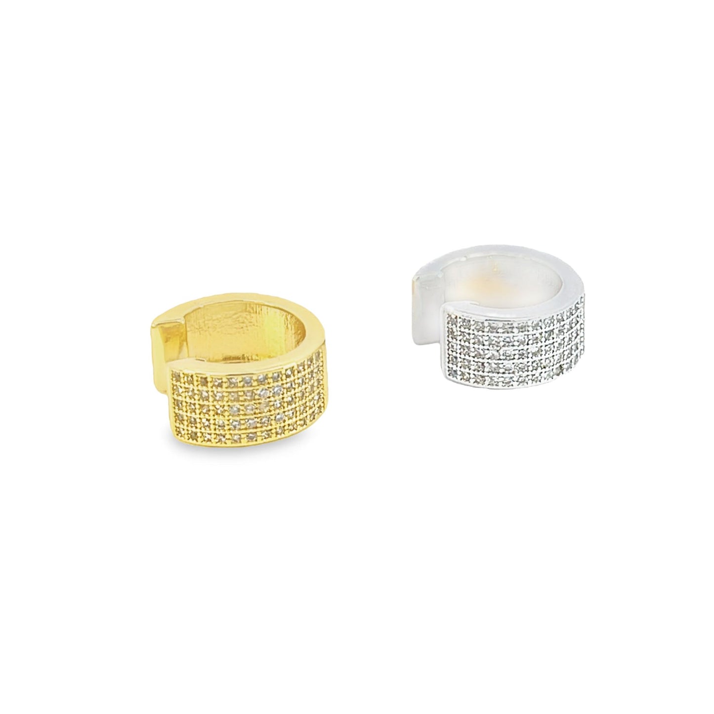 A gold and a silver pavé ear cuff sparkle against a clean white background.