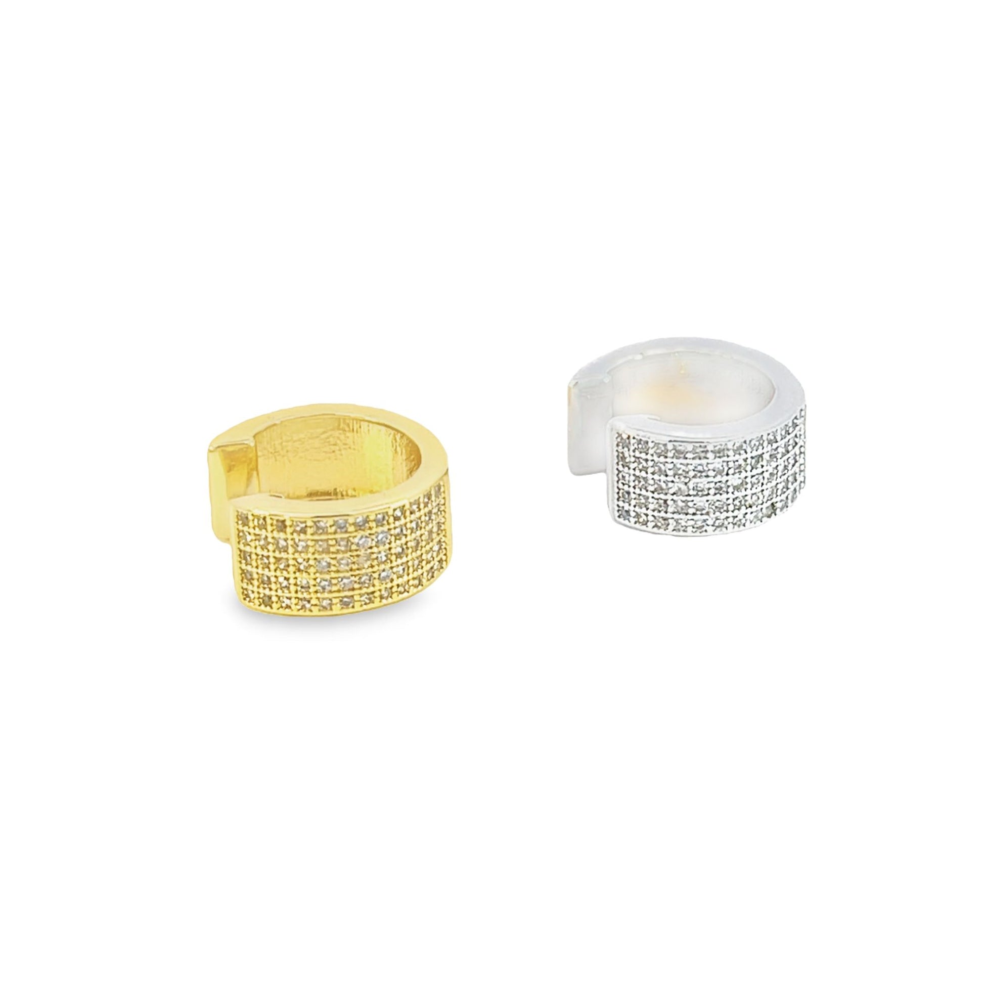 A gold and a silver pavé ear cuff sparkle against a clean white background.