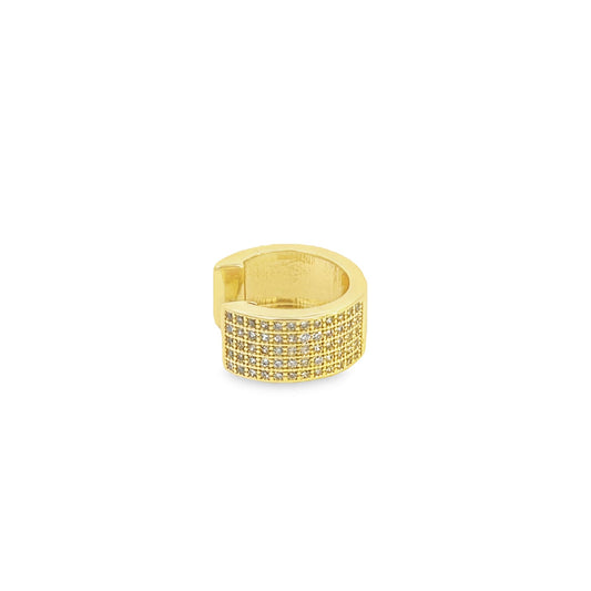 A gold ear cuff sparkles with multiple rows of tiny pave-set diamonds against a plain white background.