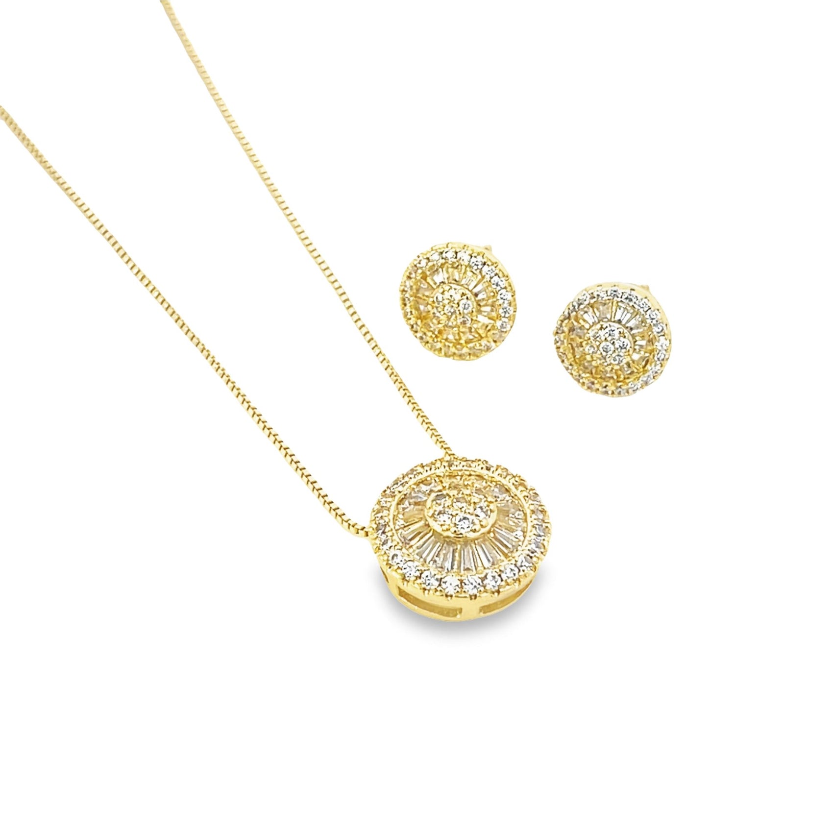 A matching gold jewelry set features a delicate chain necklace and circular stud earrings sparkling with embedded diamonds.