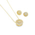 A matching gold jewelry set features a delicate chain necklace and circular stud earrings sparkling with embedded diamonds.