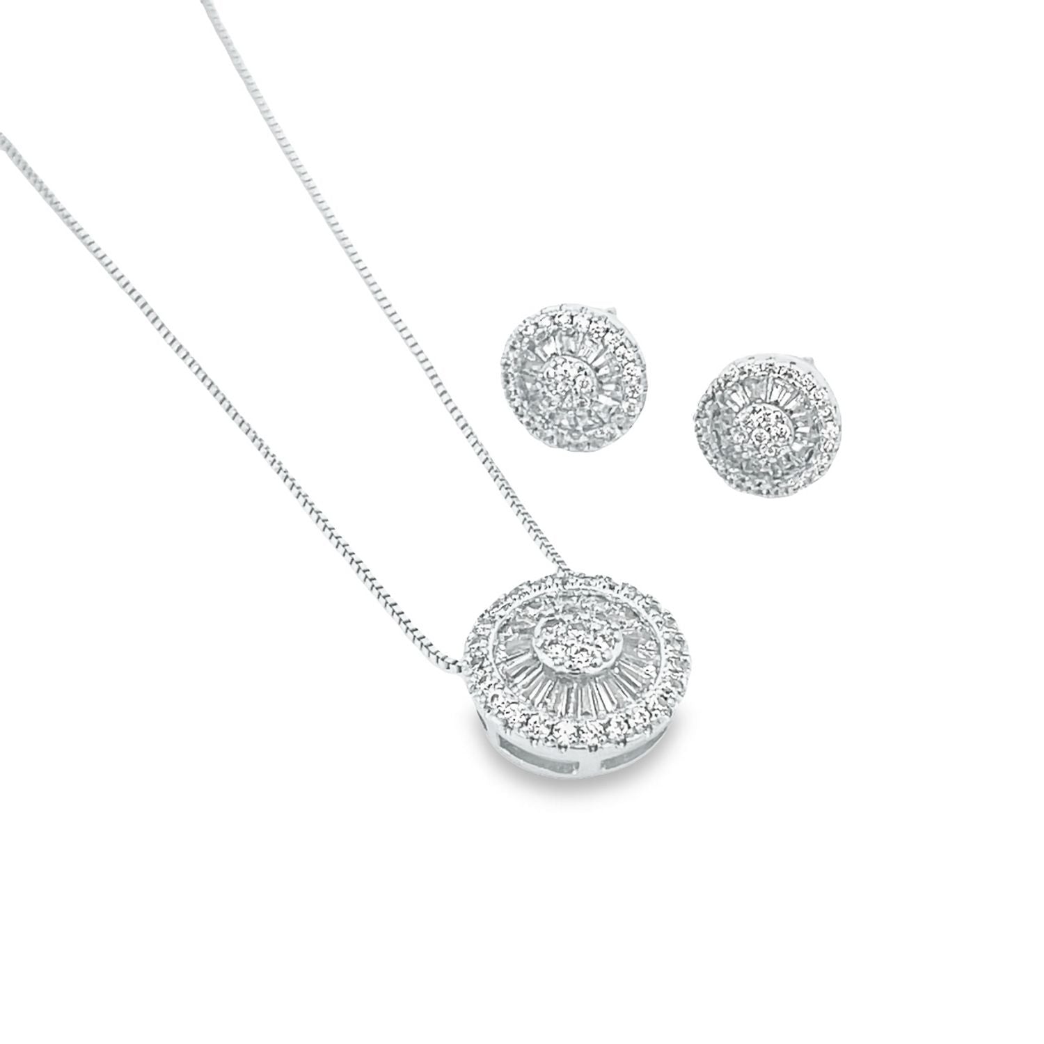 A sparkling silver diamond pendant necklace rests beside matching round cluster stud earrings on a clean white background.