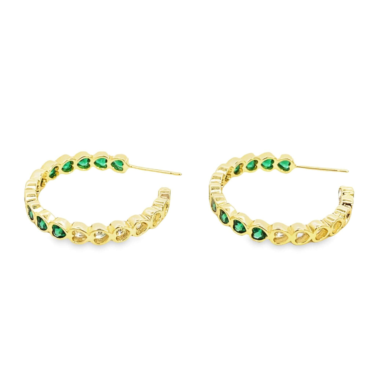 A pair of gold hoop earrings features alternating green and clear stones set against a white background.