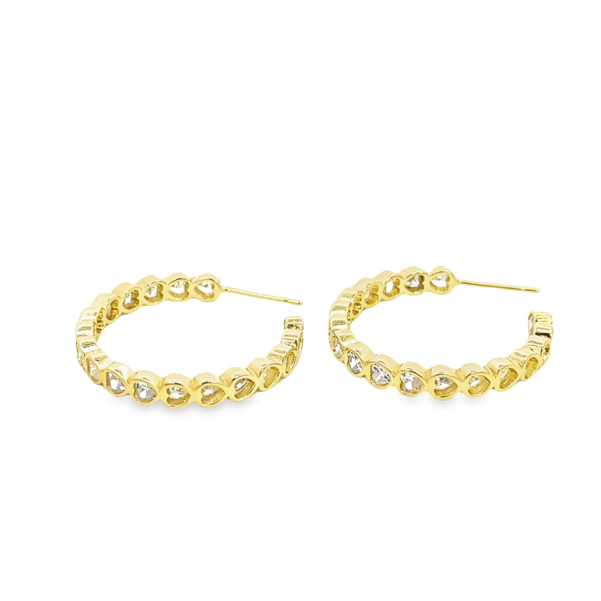 A pair of gold hoop earrings features a continuous row of sparkling diamond heart-shaped stones against a clean white background.
