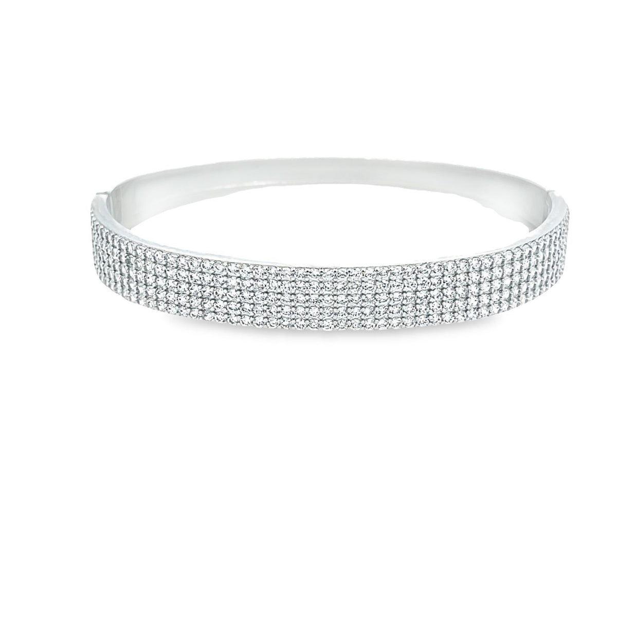 A gleaming silver hinged bangle bracelet shimmers with rows of pavé-set white crystals against a clean white background.