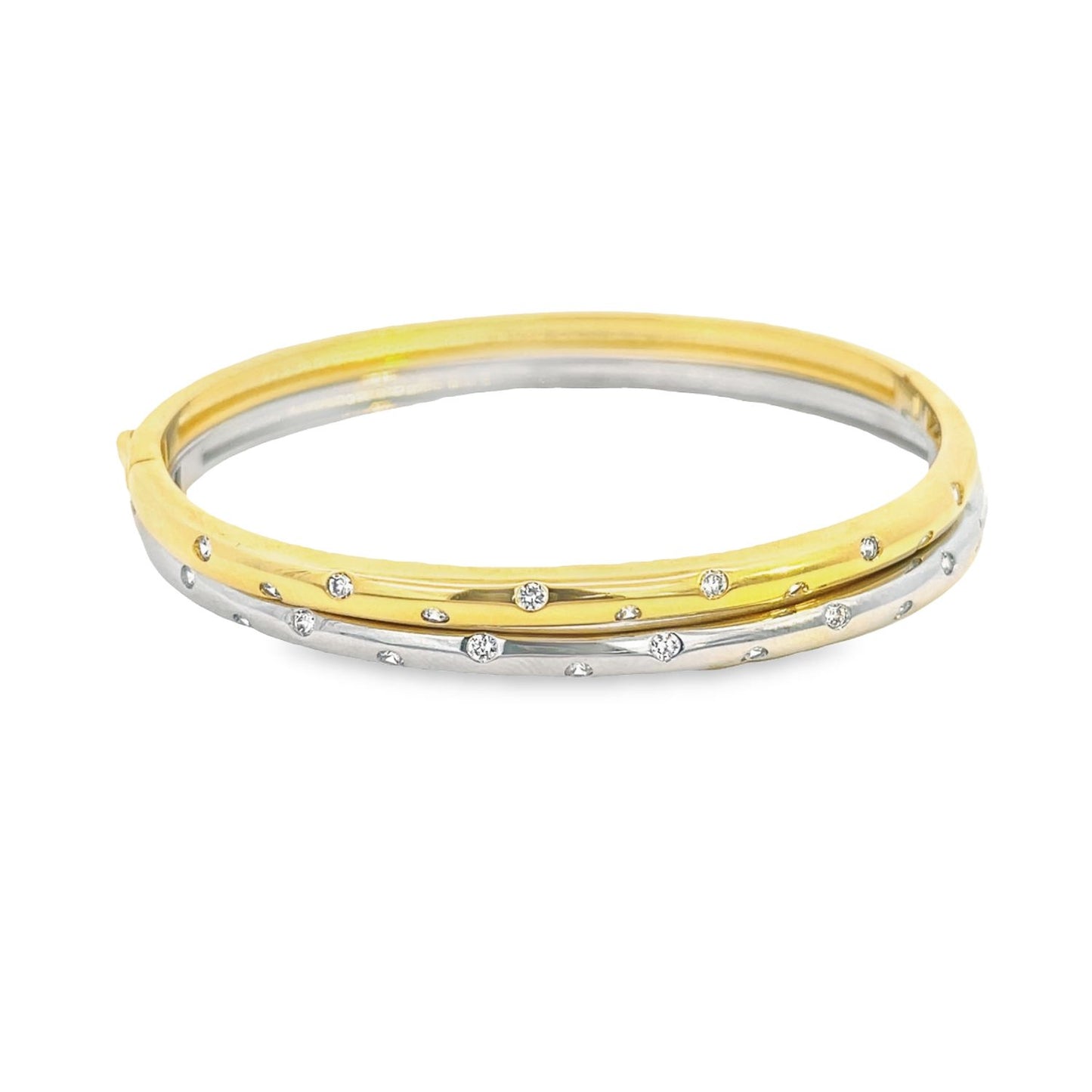 A two-tone gold and silver hinged bangle bracelet sparkles with flush-set diamonds against a clean white background.