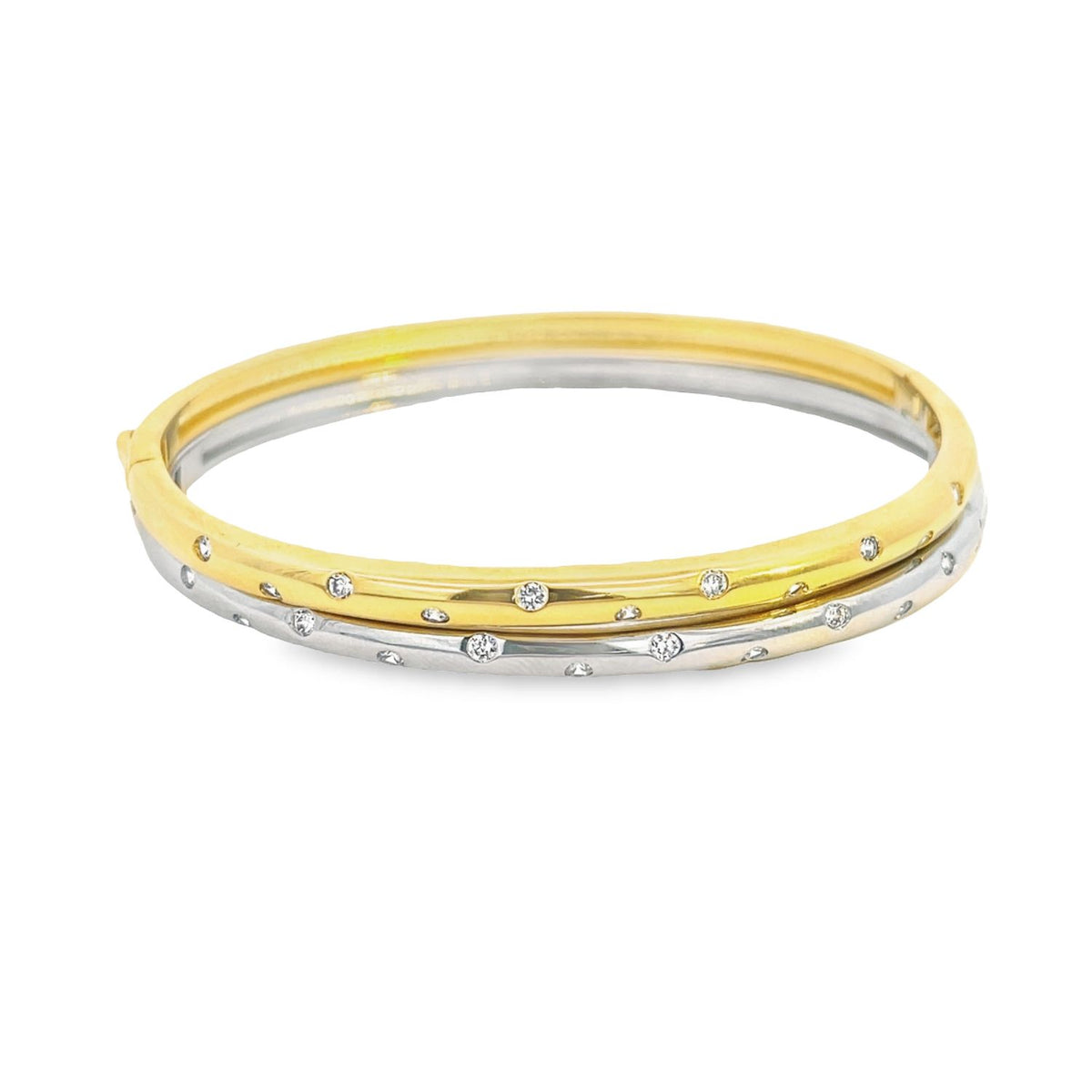 An elegant two-tone gold and silver hinged bangle bracelet sparkles with flush-set diamonds against a clean white background.