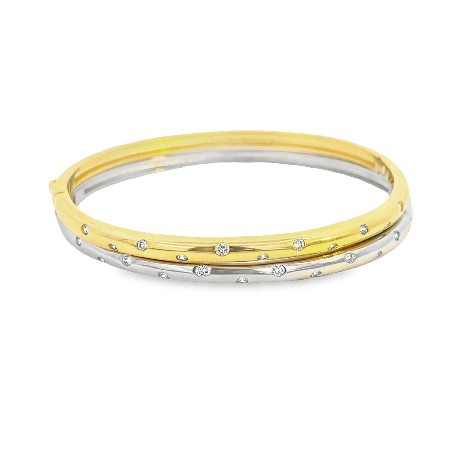 A two-tone gold and silver hinged bangle bracelet sparkles with flush-set diamonds against a clean white background.