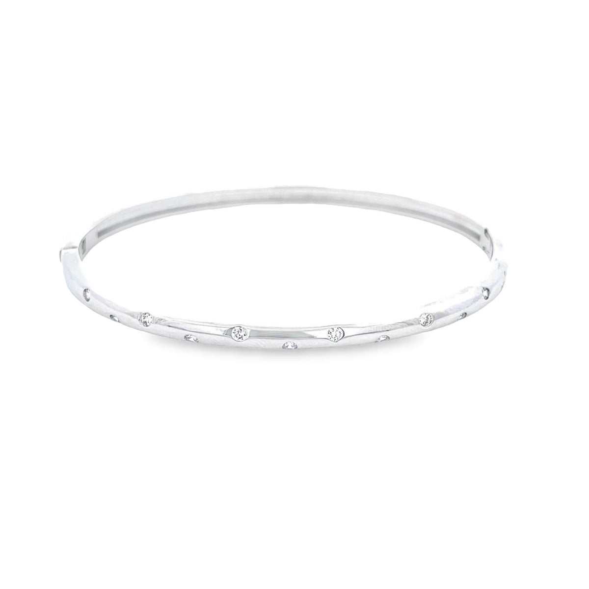 A slender silver bangle bracelet sparkles with scattered flush-set diamonds against a clean white background.