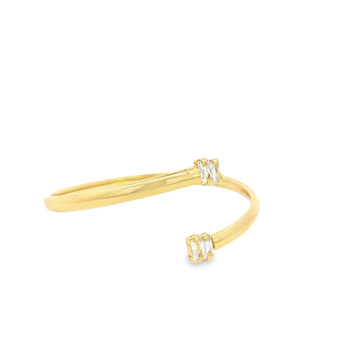 A sleek gold bypass ring features sparkling baguette-cut diamonds set on each open end.