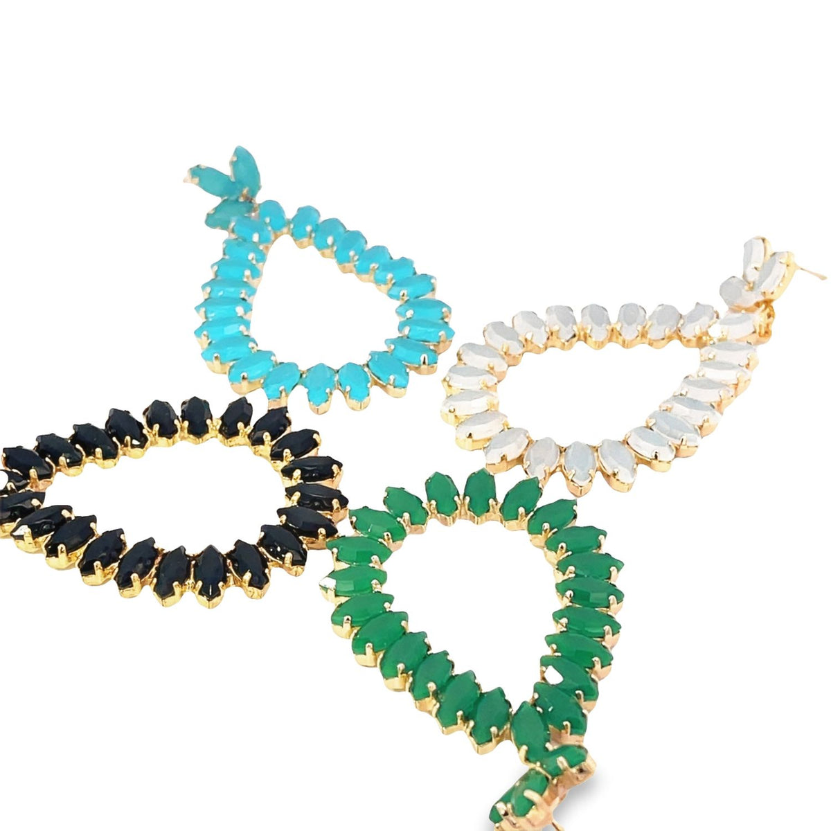 Four colorful teardrop-shaped gemstone earrings sparkle against a clean white background, showcasing vibrant turquoise, deep black, lush green, and iridescent white crystals set in gold.
